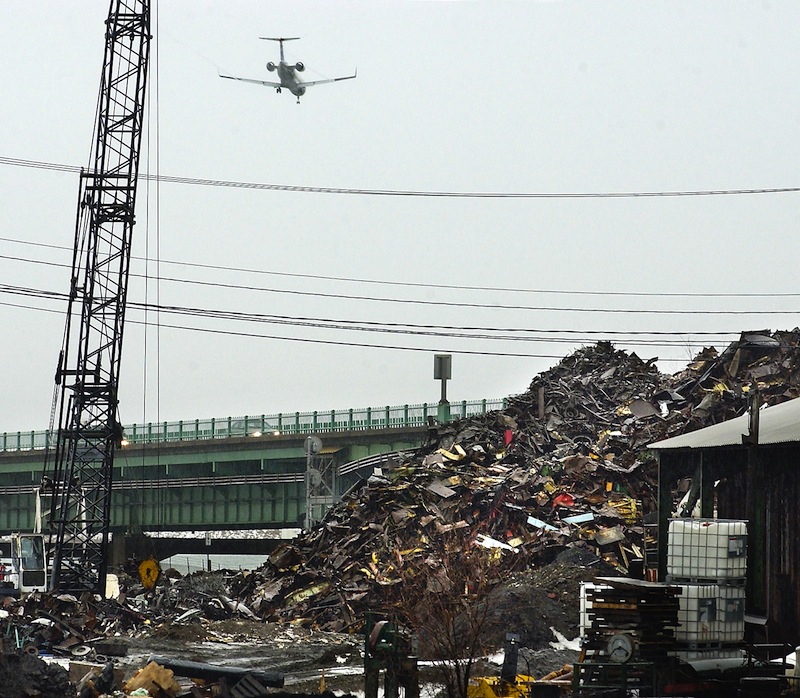 In this 2005 file photo, a jet flies over a scrap-metal yard between the Merrill Marine Terminal and the Veterans Bridge. One of many new Maine laws broadens the form of payment allowed by scrap-metal dealers for materials they buy to credit or debit cards. An earlier law allowed only checks.