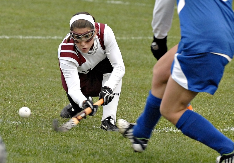 Hannah Prince of Gorham sweeps in with a low shot in this 2010 photo. Field Hockey