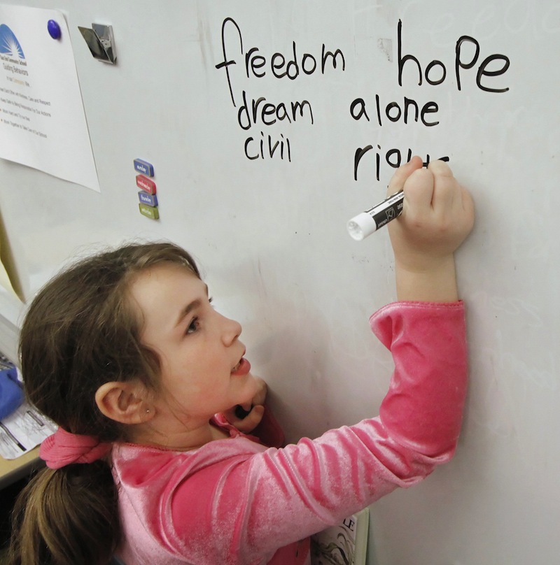 Tianna Currier, a third-grade student at East End Community School in Portland, writes how she feels about Martin Luther King Jr. in this 2011 file photo. East End School has seen a 34 percent rise in combined math and reading test scores in the past two years, as well as improved attendance, since receiving a federal School Improvement Grant