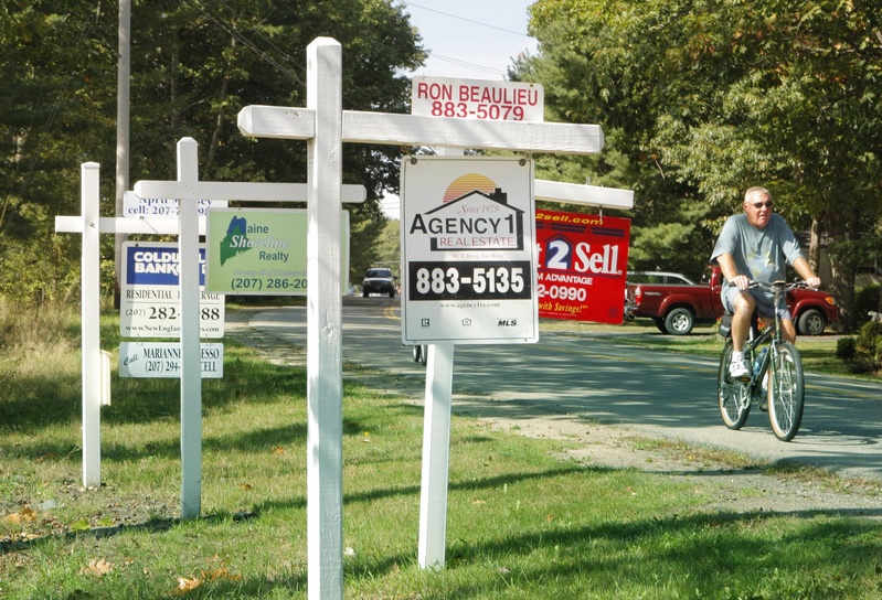 For sale signs dot the lawn outside a condominium complex in Old Orchard Beach in 2010.