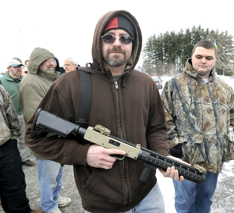 Ned Savage from Sidney, Maine lines up before for the Augusta Gun Show in January. A bill that would have mandated background checks before all gun sales, as well as certification or training before all purchases, has been significantly weakened, and will include neither of those measures.