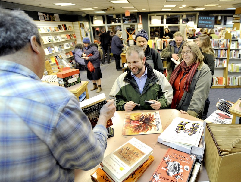Josh Tiffany and his wife Heather Brigham Tiffany buy several books as patrons crowd the Longfellow Bookstore in Portland on Feb.14, 2013. The Maine Senate killed a bill Thursday, June 20, 2013 that would have allowed towns and cities to levy a sales tax on goods if they so preferred.