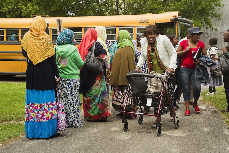 Students in Portland's Adult Education program wait to board the school bus as the next wave of students get off at the West School in Portland on Thursday June 13, 2013.