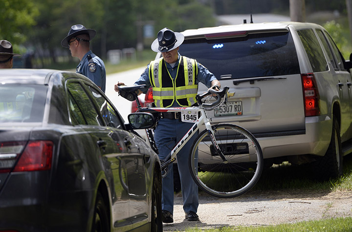 State police move a bike that was involved in a fatal crash in Hanover on Friday. David LeClair, a 23-year-old cyclist from Watertown, Mass., was struck by a tractor-trailer just miles from the starting point of the annual Trek Across Maine cycling event.