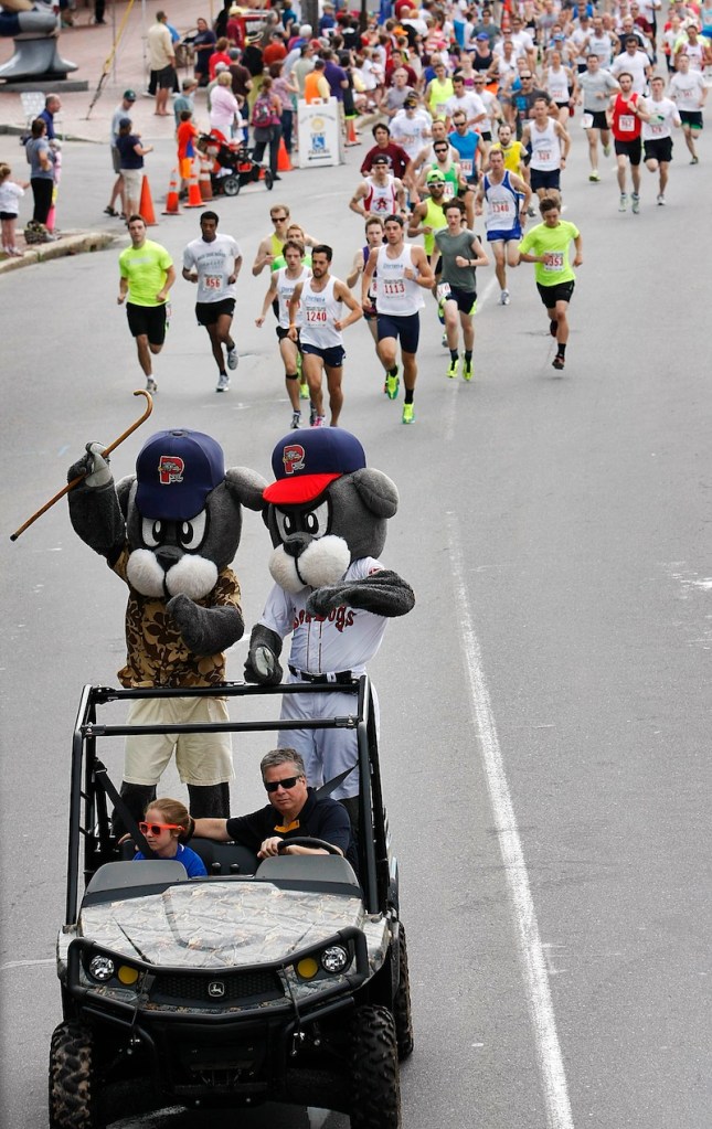 Slugger and his dad escort runners from the start of the Portland Sea Dogs Father's Day 5K.