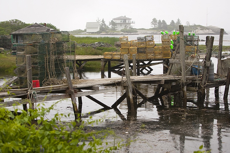 Lobster traps are stored last week on the wharf of Harbor d’Grace in the town of Long Island, a 45-minute ferry ride from Portland.