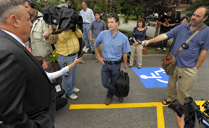 Dean Kamen, center, inventor of the Segway PT, speaks with Gov. Paul LePage, far left, as the media gather outside Fairchild Semiconductor in South Portland Thursday.