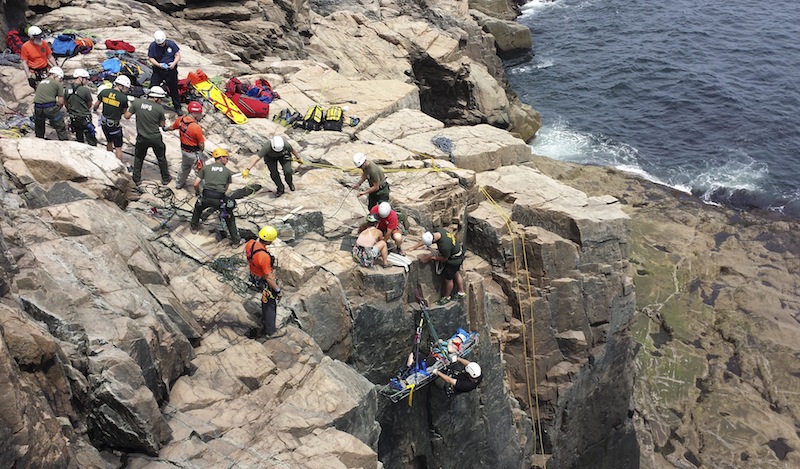 A climber is lifted during a rescue after a climbing accident at the rock face at Otter Cliffs in Acadia National Park in Bar Harbor. Two climbers fell onto a third after a rope broke, park rangers said.