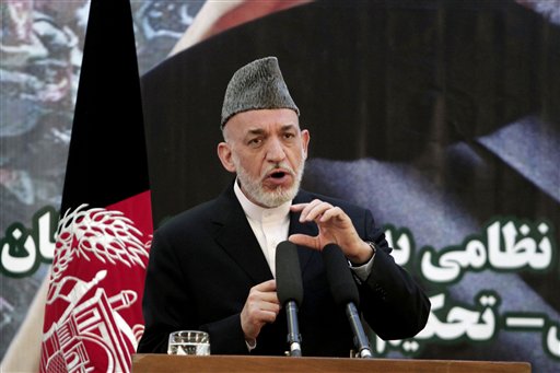 Afghan President Hamid Karzai speaks at a press conference during a ceremony at a military academy on the outskirts of Kabul, Afghanistan, on Tuesday, as Afghan forces take over the lead from the U.S.-led NATO coalition for security nationwide.