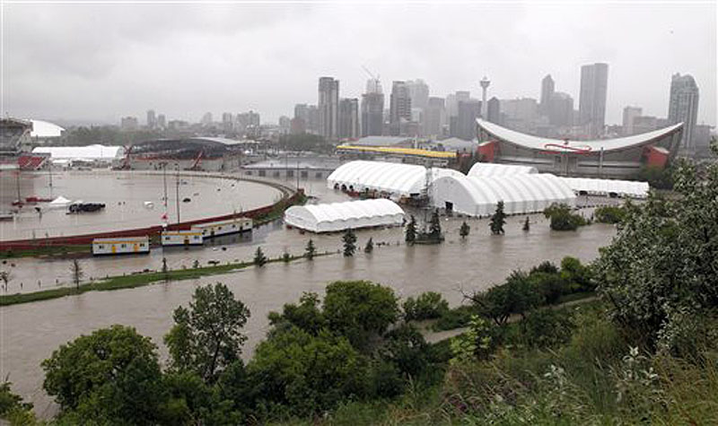The Calgary Stampede grounds and Saddledome are flooded due to heavy rains in Calgary, Alberta, on Friday. Flooding forced the western Canadian city to order the evacuation of the entire downtown area on Friday, as the waters reached the 10th row of the city's hockey arena. Canada;Canadian;Alberta;AB;flooding;flood;water;evacuate;rise;we