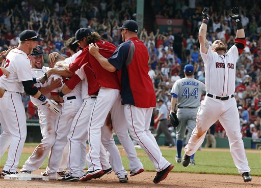 Boston's Shane Victorino, partially hidden third from left, celebrates with teammates after a fielding error by Toronto' Josh Thole in Boston on Sunday. The Red Sox won 5-4.