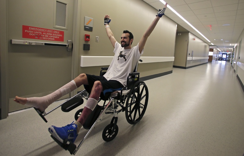 Boston Marathon bombing survivor Pete DiMartino, of Rochester, N.Y., raises his arms after completing a physical therapy session at the Spaulding Rehabilitation Hospital in Boston last month. DiMartino was among those applying for aid through a fund set up for survivors.