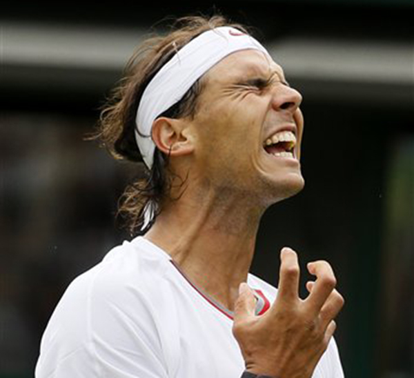 Rafael Nadal of Spain reacts as he loses a point to Steve Darcis of Belgium during their men's first round singles match at Wimbledon Monday.