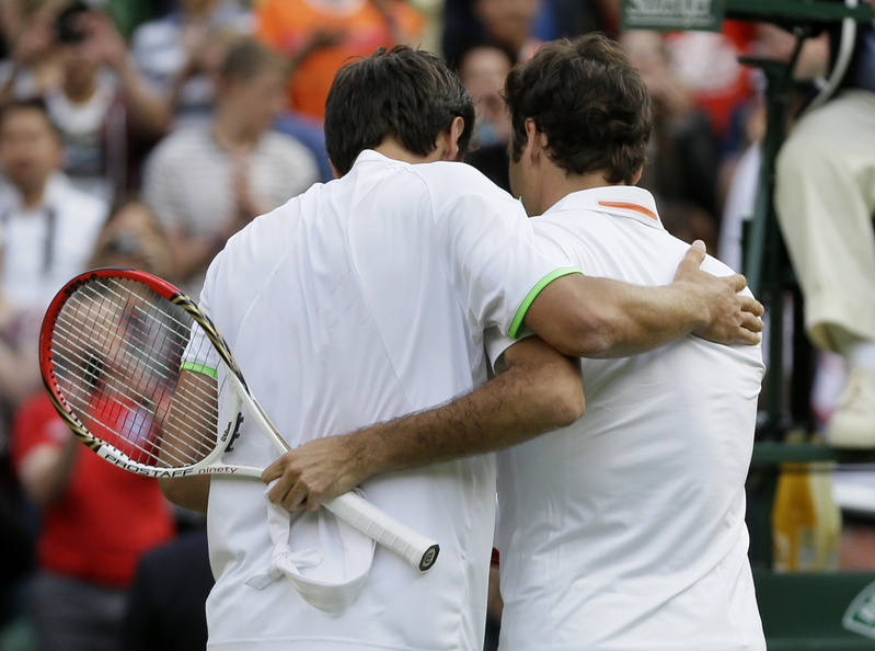Sergiy Stakhovsky of Ukraine, left, speaks with Roger Federer of Switzerland after he defeated him in their men's second-round singles match at Wimbledon in London on Wednesday.