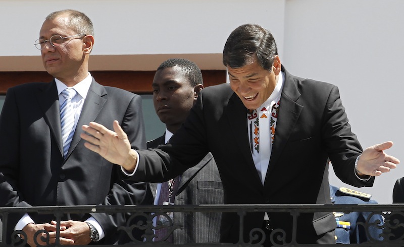 Ecuador's President Rafael Correa, right, greets passersby from the balcony of the presidential palace during the weekly, The Change of the Guard, in Quito, Ecuador, Monday, June 24, 2013. Correa declared Monday that national sovereignty and universal principles of human rights would govern his decision on granting asylum to Edward Snowden, powerful hints that the former National Security Agency contractor is welcome in Ecuador despite potential repercussions from Washington. Correa said on Twitter that "we will take the decision that we feel most suitable, with absolute sovereignty." Vice president Jorge Glass is pictured left. (AP Photo/Dolores Ochoa)