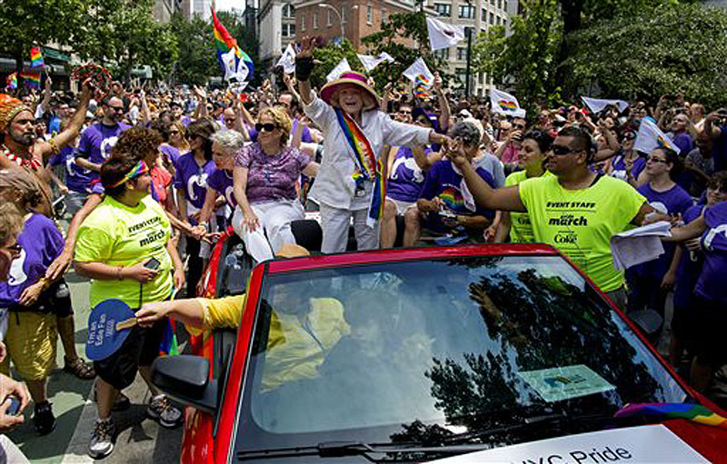 Grand Marshal Edith Windsor, the 84-year-old woman at the center of the U.S. Supreme Court decision granting gay couples federal marriage benefits, is surrounded by well wishers during the gay pride march in New York Sunday.