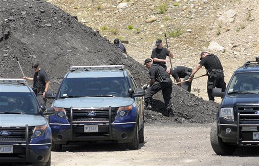 Massachusetts State Police dig for evidence on Thursday at the site in an industrial park in North Attleborough, Mass., where the body of Odin Lloydwas found earlier this week.