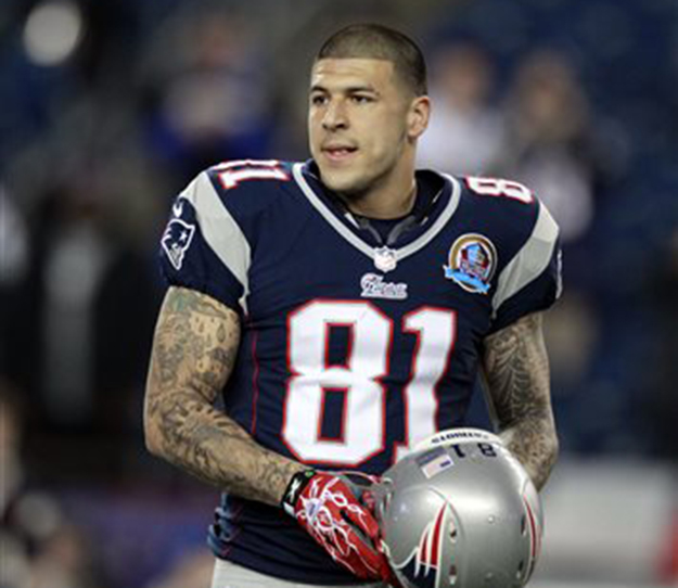 Massachusetts state and local police spent hours at his home of New England Patriots tight end Aaron Hernandez on Tuesday as another group of officers searched an industrial park about a mile away where a body was discovered the day before.
