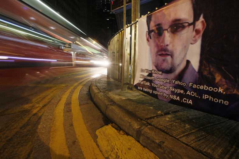 A bus drives past a banner supporting Edward Snowden, a former CIA employee who leaked top-secret documents about sweeping U.S. surveillance programs, in Hong Kong's business district this week.