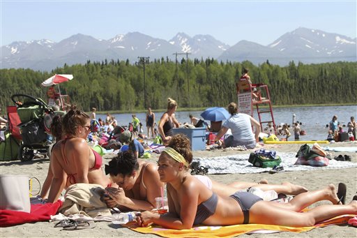 Sunbathers flock to Goose Lake in Anchorage, Alaska, on Monday. Temperatures are nothing like what Phoenix or Las Vegas gets, but temperatures in the 80s and 90s are hot for Alaska, where few buildings have air conditioning.