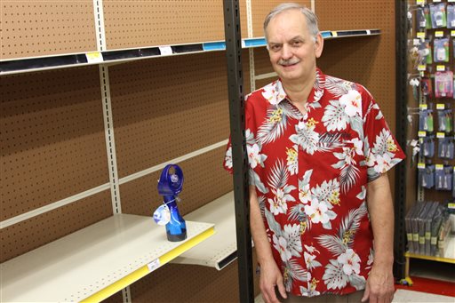 Anchorage True Value owner Tim Craig stands next to the last fan he had available for sale at the store in south Anchorage on Tuesday. He said he sold his entire stock of fans in 10 days.