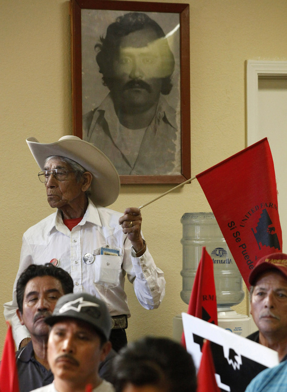 Adan Ramirez stands under a portrait of Rufino Contreras during a meeting at the United Farm Workers office in Salinas, Calif., to discuss the immigration reform bill on Thursday. Contreras was killed during a labor strike in 1979.