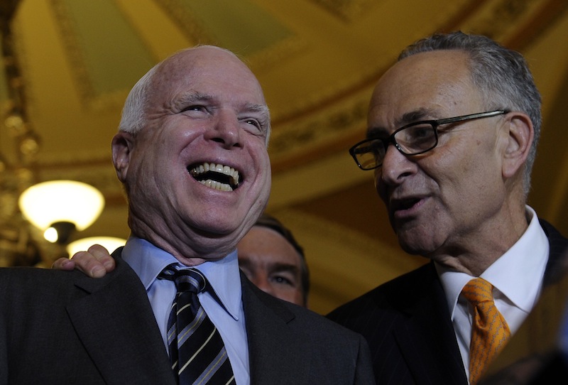Sen. Charles Schumer, D-N.Y., right, shares a laugh with Sen. John McCain, R-Ariz., following a vote in the Senate on immigration reform on Thursday. The Senate passed historic immigration legislation offering the hope of citizenship to millions of immigrants living illegally in America's shadows. The bill will now go to the House where prospects for passage are highly uncertain.