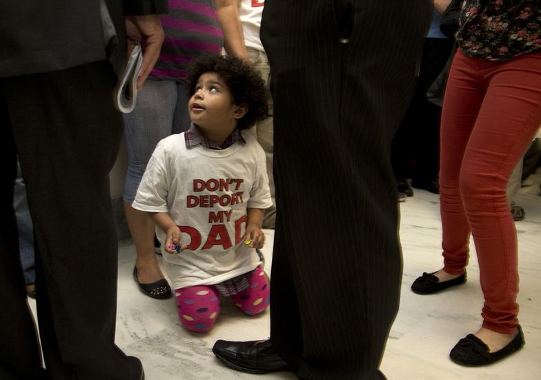 Jackelin Alfaro, 4, in a T-shirt that reads "Don't Deport my Dad," sits in the hall with family members outside the House Judiciary Committee hearing on Capitol Hill in Washington on Tuesday.
