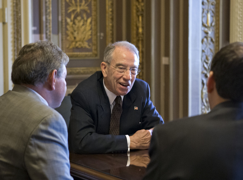 Sen. Chuck Grassley, R-Iowa, holds a meeting just off the floor of the Senate prior to a vote on a border security amendment to the immigration bill at the Capitol in Washington on Monday.