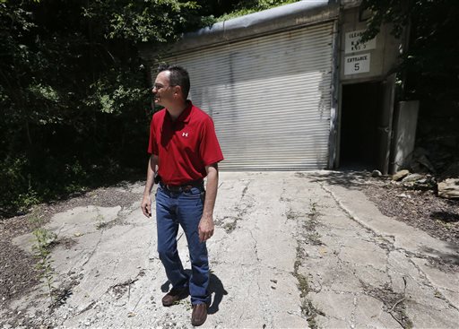 Coby Cullins stands next to an entrance to the Vivos Shelter and Resort during a tour of the facility.