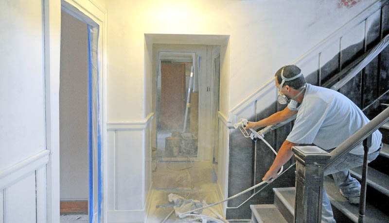 Mike Gough primes the walls during renovations of upstairs apartments in the former Levine's clothing building on Main Street in downtown Waterville. The apartments, once finished, will be rented for around $600 per month.