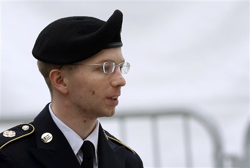 Army Pfc. Bradley Manning is escorted into a courthouse in Fort Meade, Md., before a pretrial military hearing in this May 21, 2013, photo.