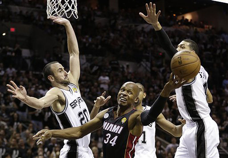 Miami Heat's Ray Allen loses the ball as San Antonio Spurs' Manu Ginobili, Tim Duncan and Danny Green defend during the second half of Game 5 of the NBA Finals in San Antonio on Sunday. The Spurs won 114-104.