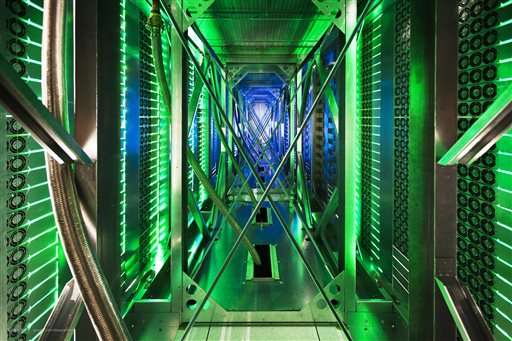 In this undated photo made available by Google, hundreds of fans funnel hot air from the computer servers into a cooling unit to be recirculated at a Google data center in Mayes County. Okla. The green lights are the server status LEDs on the from of the servers.