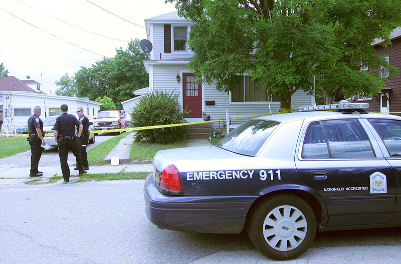 Nashua police stand outside a Newbury Street home Monday in Nashua, N.H., where a married couple were found dead.