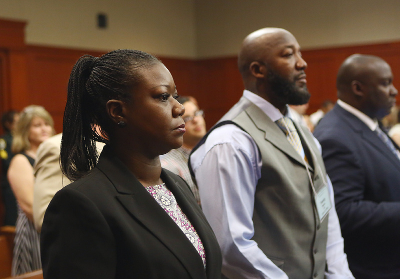 Trayvon Martin's parents, Sybrina Fulton, left, and Tracy Martin, center, attend George Zimmerman's trial in Seminole circuit court in Sanford, Fla., on Thursday. Zimmerman has been charged with second-degree murder for the 2012 shooting death of Trayvon. george-zimmerman-trial-day-14