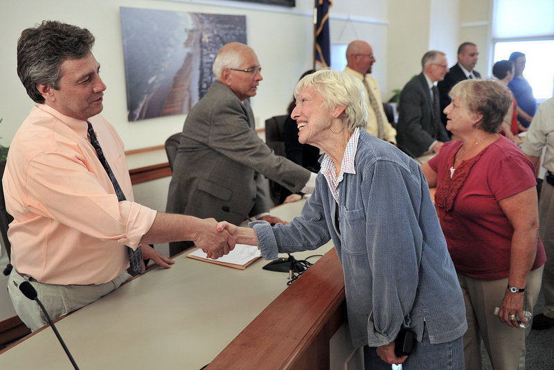 Newly elected Old Orchard Beach town council members were sworn in Monday, June 17, 2013. In this photo, OOB resident Elizabeth Mills greets newly elected council member Kenneth Blow following the meeting.