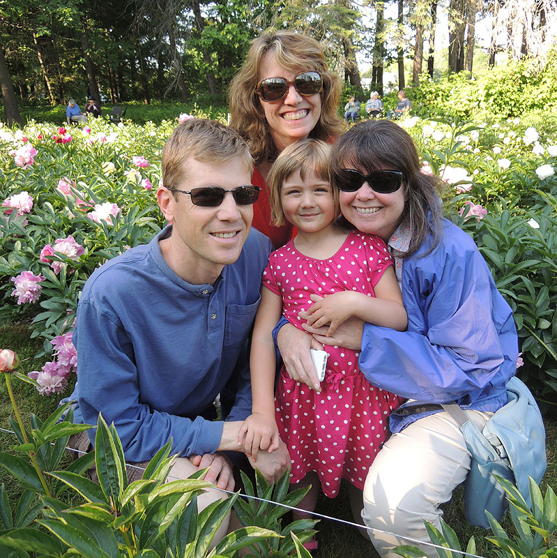 John Knight, 5-year-old Chloe Knight, Kathleen Parr and Marie Corkery enjoy the formal peony garden at Gilsland Farm.