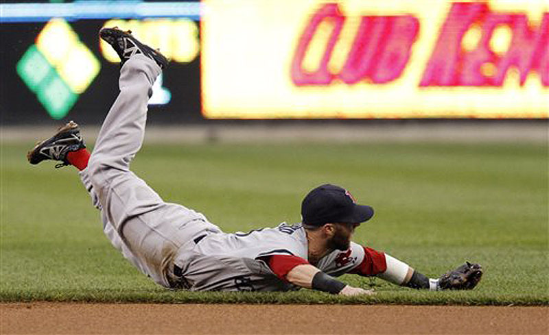 Boston second baseman Dustin Pedroia lands on the field after making a diving attempt on a single by Detroit's Andy Dirks Saturday in Detroit.