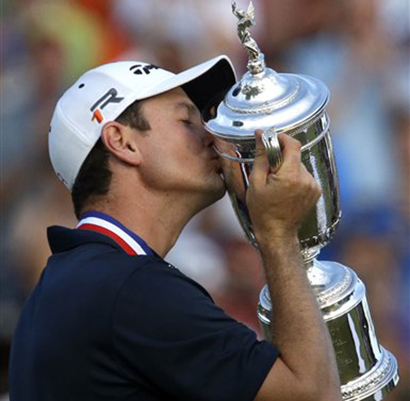 Justin Rose, born in South Africa and raised in England, celebrates with the trophy after winning the U.S. Open golf tournament at Merion Golf Club in Ardmore, Pa., on Sunday.