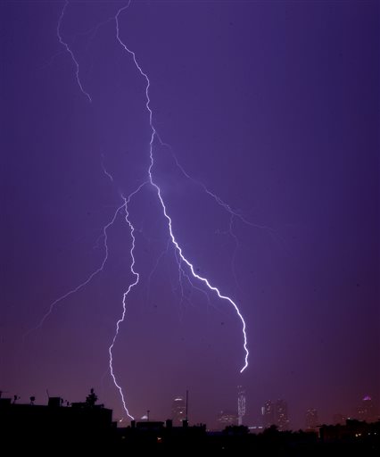 Lightning strikes over One World Trade Center, center right, during a thunderstorm seen from The Heights neighborhood of Jersey City, N.J., on Sunday.