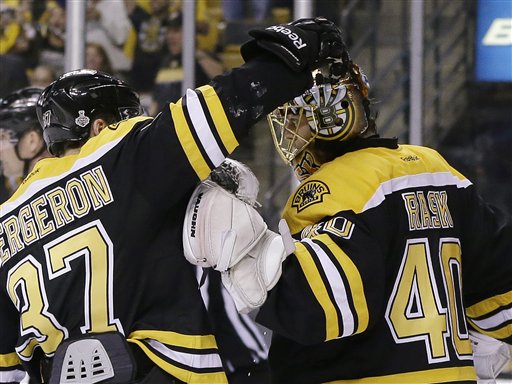 Boston Bruins center Patrice Bergeron congratulates goalie Tuukka Rask on his shutout of the Chicago Blackhawks in Game 3 of the Stanley Cup Finals on Monday.