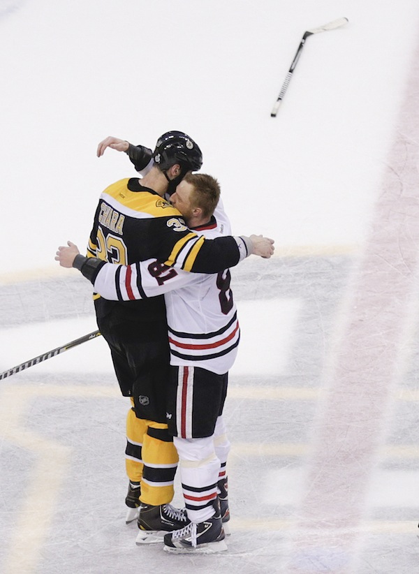 Boston Bruins defenseman Zdeno Chara (33), hugs Chicago Blackhawks right wing Marian Hossa (81), both of Slovakia, after the Blackhawks beat the Bruins 3-2 in Game 6 of the NHL hockey Stanley Cup Finals, Monday, June 24, 2013, in Boston. (AP Photo/Charles Krupa) TD Garden