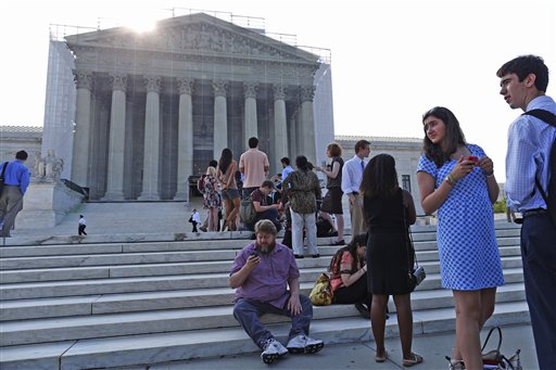 People line up in front of the Supreme Court in Washington on Monday before it opened for its last scheduled session.