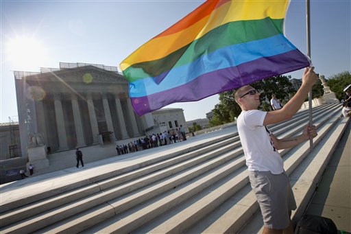 Vin Testa of Washington waves a rainbow flag in support of gay rights outside the Supreme Court in Washington on Tuesday. The broadest possible ruling by the court would give gay Americans the same constitutional right to marry as heterosexuals.