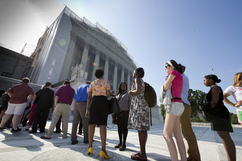 Visitors wait outside the Supreme Court in Washington on Thursday in anticipation of key decisions being announced.