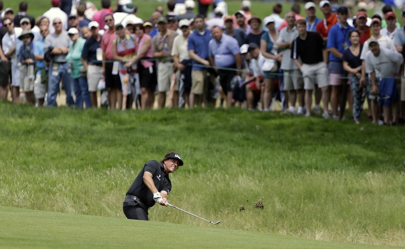 Phil Mickelson hits on the fifth hole during the first round of the U.S. Open golf tournament at Merion Golf Club, Thursday, June 13, 2013, in Ardmore, Pa. (AP Photo/Darron Cummings)
