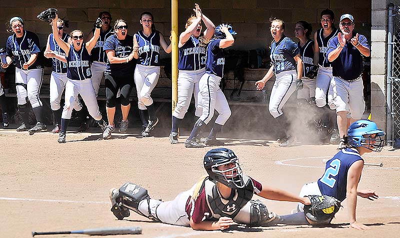 Oceanside players cheer as their first run is scored by Abby Herson to make it 1-1 in the sixth inning Saturday in the Class B state softball final in Standish. Oceanside rallied for an 8-1 win over Greely.