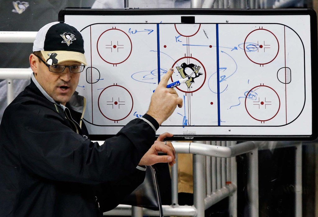 In this Jan. 14, 2013, file photo, Pittsburgh Penguins Coach Dan Bylsma outlines a drill during practice. USA Hockey hired Bylsma on Saturday as the coach for the U.S. Olympic men's hockey team at the 2014 games in Sochi, Russia.
