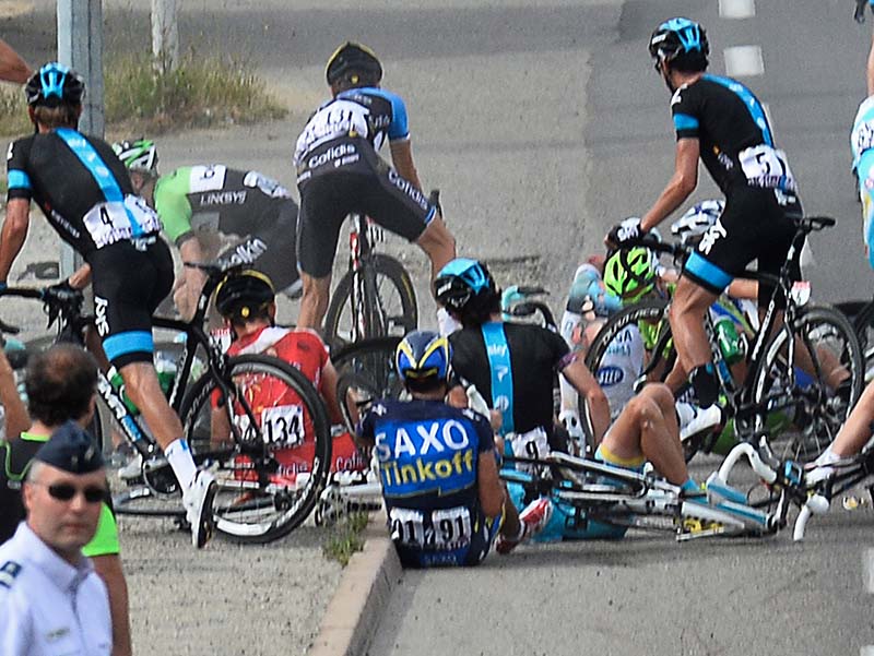 Alberto Contador of Spain, center with number 91, sits on the road after a group of riders crashed during the first stage of the Tour de France cycling race on Saturday.